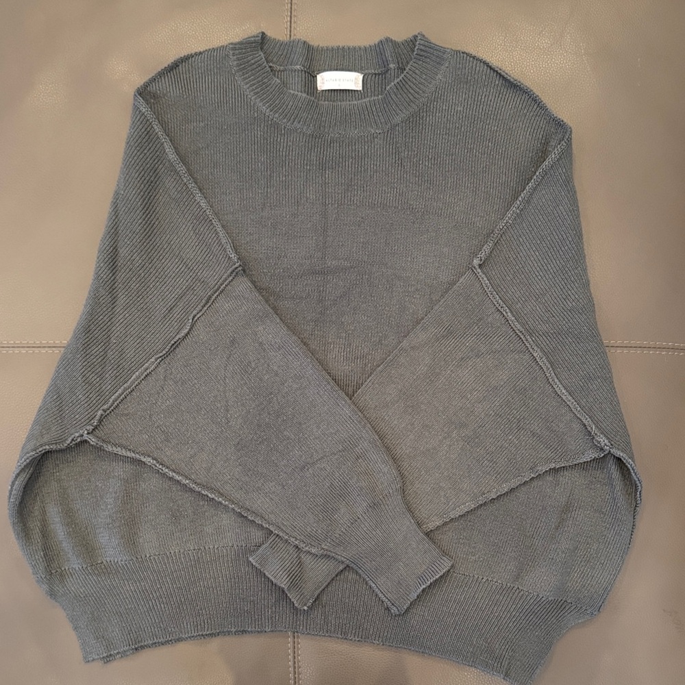 Woman’s dark olive green oversized sweater